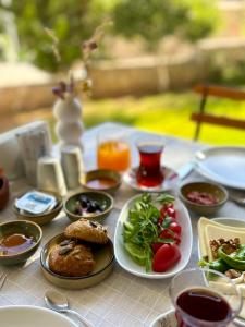 a table with plates of food on top of it at Hotel Villa Tokur in Datca