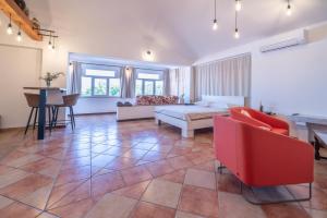 a living room with a bed and a table and chairs at Studio apartma Kamin in Nova Vas