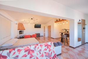 a bedroom with a bed and a living room at Studio apartma Kamin in Nova Vas