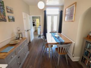 a kitchen with a table and a dining room at Pankhurst Cottage in Louth