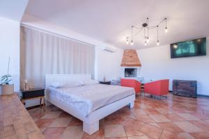 a bedroom with a bed and two chairs and a fireplace at Studio apartma Kamin in Nova Vas