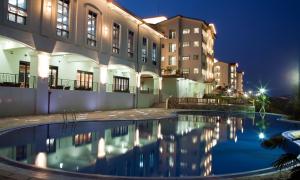 a pool in front of a building at night at Sagewood Yeosu Gyeongdo Resort in Kyŏngho-dong