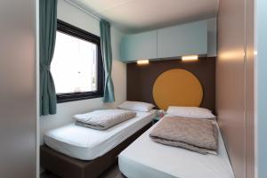 a room with two beds and a window at EUROCAMPINGPACENGO in Lazise +37 photos