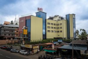 a city with tall buildings and a street with cars at Luxo Wayanad in Sultan Bathery
