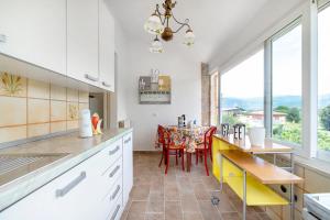 a kitchen with a table with chairs and a dining room at Casa Ortensia in Spoleto
