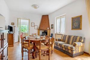 a living room with a table and a couch at Casa Ortensia in Spoleto