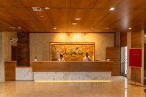 two people standing at the counter of a restaurant at Luxo Wayanad in Sultan Bathery +66 photos