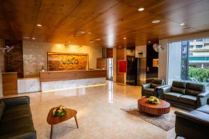 a lobby with couches and chairs and a table at Luxo Wayanad in Sultan Bathery