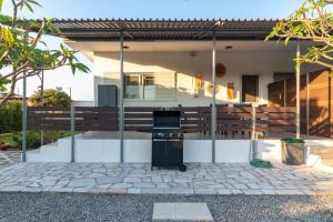 a barbecue grill in the front of a house at Beachside Apartment-2 in Afantou