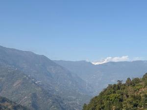 a view of a valley in the mountains at Karki Farm Stay in Bijanbāri Bāzār +4 photos