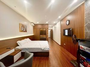 a bedroom with a bed and a tv in it at NBZ Homestay in Hanoi