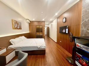 a bedroom with a bed and a tv in a room at NBZ Homestay in Hanoi