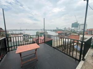 a balcony with a bench and a view of the water at NBZ Homestay in Hanoi