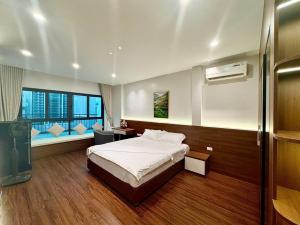 a bedroom with a bed and a desk and a window at NBZ Homestay in Hanoi