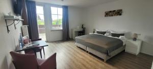 a bedroom with a bed and a desk and a desk at Hotel Rosenhof - Braunlage in Braunlage