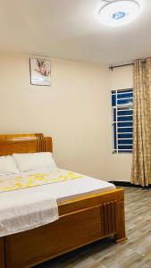 a bedroom with a bed and a window at Varine House in Dodoma