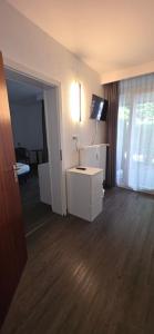 a living room with a white dresser and a television at Aparthotel Höper in Oyten +51 photos