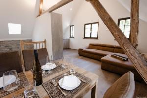 a living room with a table and a couch at Haus Auf der Zinn in Beilstein