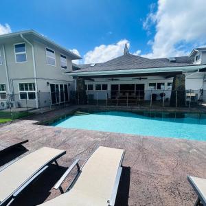 a swimming pool in front of a house at Hale Halai in Hauula