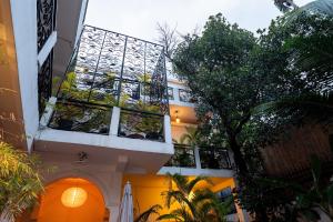 a building with a balcony with plants on it at Samaya Boutique & Cuisine in Phnom Penh