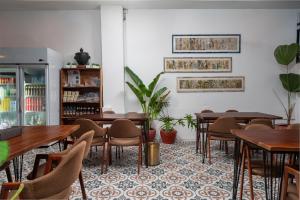 a dining room with wooden tables and chairs at Samaya Boutique & Cuisine in Phnom Penh
