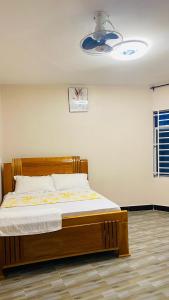 a bedroom with a wooden bed in a room at Varine House in Dodoma +30 photos
