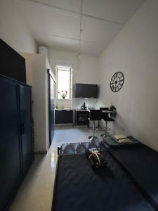 a room with a bed and a clock on the wall at Hypogeum SuiteStudio in Ħal Saflieni