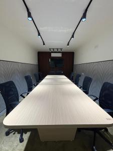 a conference room with a long table and chairs at Lucknow Courtyard in Lucknow