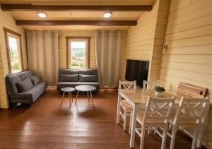 a living room with a couch and a table at The Heart Cabin בקתת הלב in Kidmat Tsvi