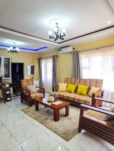 a living room with a couch and a table at Area 46 BnB in Lilongwe