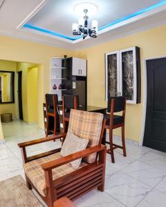 a living room with a dining room table and chairs at Area 46 BnB in Lilongwe