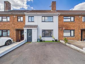 a brick house with a car parked in the driveway at The View At Alison Avenue in Bristol