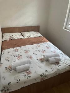 a bed with two towels on top of it at Villa Apartments STEFAN - Ramne Ohrid in Ohrid