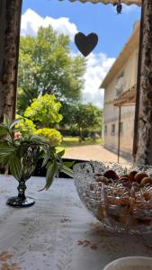 a bowl of food and a vase on a table at Vera's Home in Anaklia