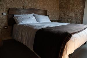 a bed with white sheets and pillows in a bedroom at Casale dei cappuccini in Scurcola Marsicana +25 photos
