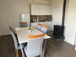 a kitchen with a table and chairs and a stove at Villa Apartments STEFAN - Ramne Ohrid in Ohrid
