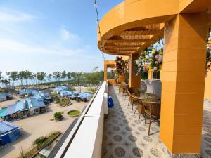 a view from the balcony of a resort with tables and chairs at Hotel Big Boss New Digha in Digha