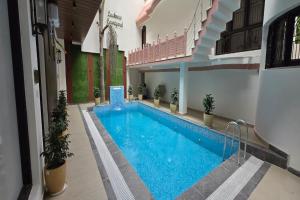 a large swimming pool in a building at Lucknow Courtyard in Lucknow