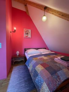 a bedroom with pink and purple walls and a bed at Villa Art Residence Überlingen in Überlingen