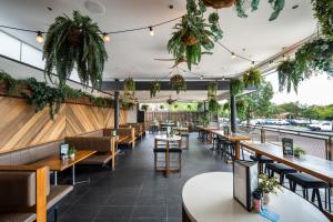 a restaurant with tables and chairs and plants at Camden Hotel Suites in Camden +17 photos