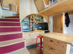 a kitchen with a staircase in a tiny house at Au Son Du Diois in Die +17 photos