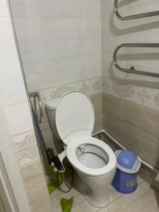 a bathroom with a white toilet in a stall at Kvartira in Toshkent-Passajir Bekati