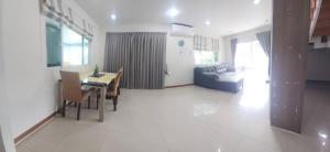 a living room with a table and a couch at The Plant Light Thiwanon in Lat Lum Kaeo