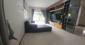 a living room with a couch and a television at The Plant Light Thiwanon in Lat Lum Kaeo +15 photos