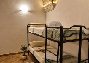 a room with two bunk beds in a room at La Corte di mezzo in Corigliano dʼOtranto