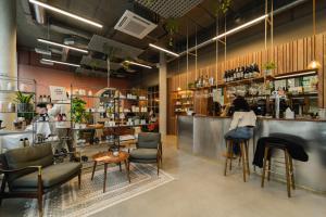a restaurant with a bar with chairs and a counter at Turing Locke Cambridge in Cambridge +16 photos