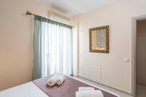 a bedroom with a bed with towels on it at Fontana La Vista in Sitia
