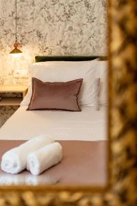 a bedroom with a bed with two towels on it at Fontana La Vista in Sitia