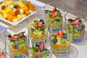 a bunch of glasses filled with fruit on a table at Hotel Penz West in Innsbruck