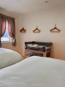 a bedroom with two beds and a window and a crib at HAKONE DOMA in Hakone